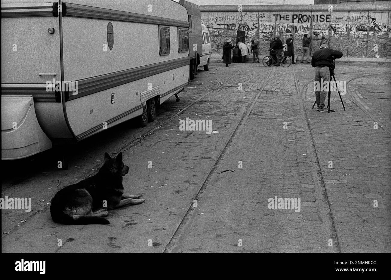 West Berlin, 01.01.1990, at the Wall at Potsdamer Platz, FotoGraf and a dog, The Promise Stock Photo