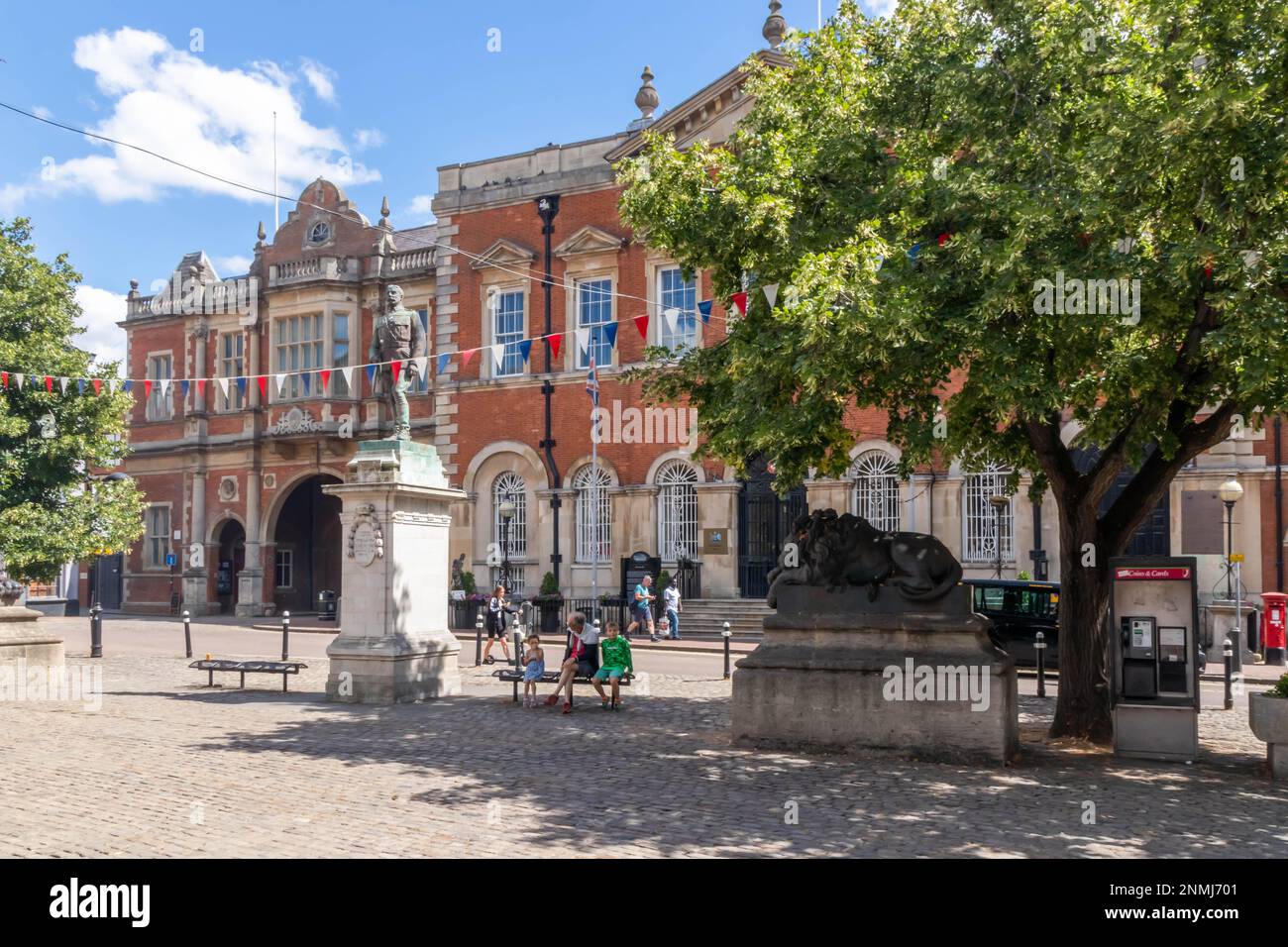 Aylesbury, England - August 5th 2022: Statue of Charles Crompton with the old County Hall in the background. This is the Market Square in the town. Stock Photo
