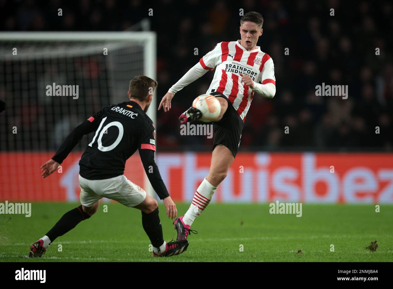 EINDHOVEN - (l-r), Ivan Rakitic of Sevilla FC, Joey Veerman of PSV Eindhoven during the UEFA Europa league play-off match between PSV Eindhoven and Sevilla FC at Phillips stadium on February 23, 2023 in Eindhoven, Netherlands. AP | Dutch Height | Jeroen Putmans Stock Photo