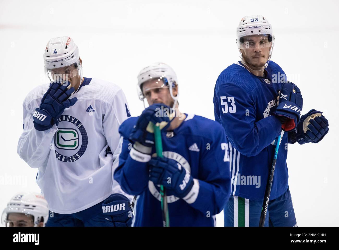 Vancouver Canucks Bo Horvat (53), Madison Bowey (4) and Oliver Ekman-Larsson, of Sweden, listen during the NHL hockey teams training camp in Abbotsford, British Columbia, on Thursday, Sept
