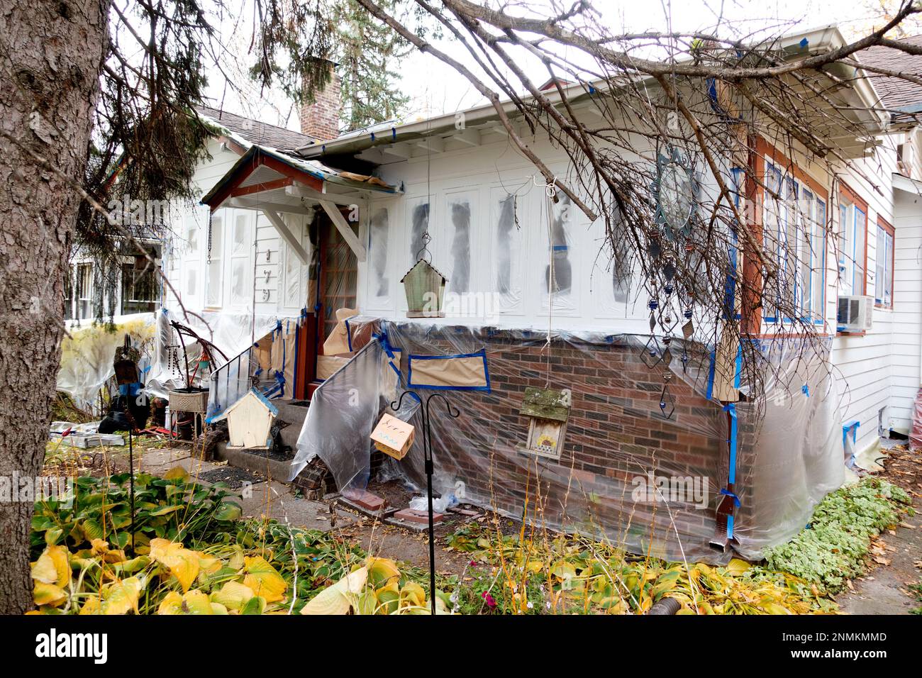 Photographer Steve Skjold's house covered with plastic in preparation for painting. St Paul Minnesota MN USA Stock Photo