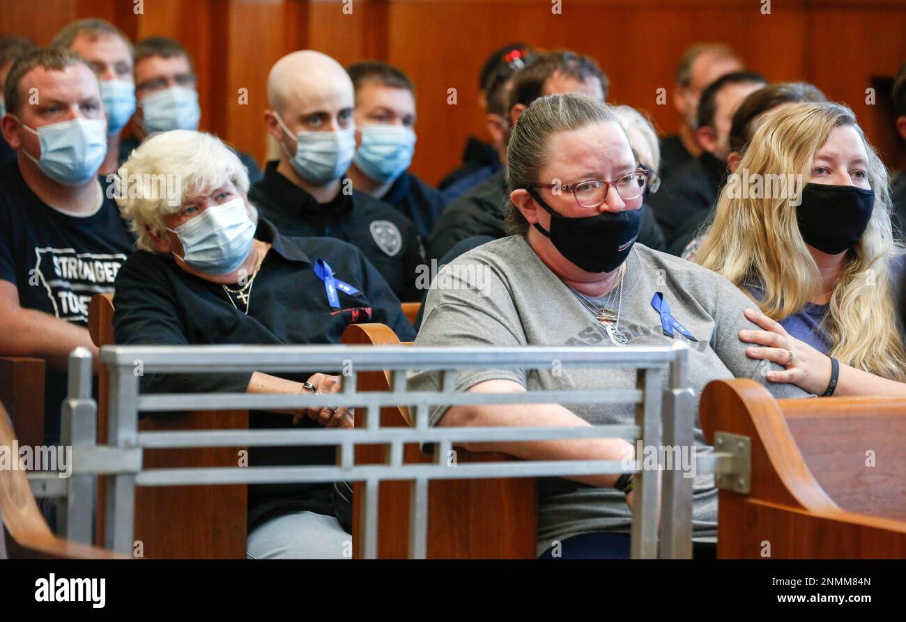 Sara McFarland , center, wife of corrections officer Robert McFarland