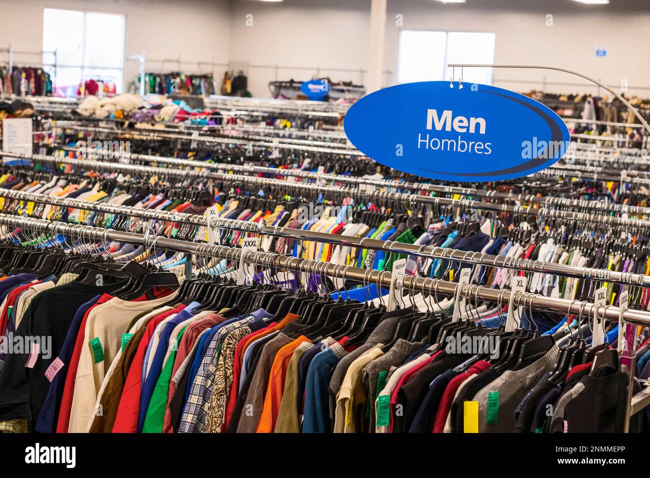 Multiple clothing racks in a thrift store(Good Will) in Ludington, Michigan, USA. Stock Photo