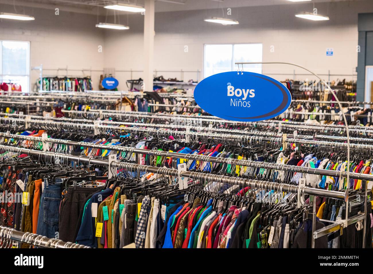 Multiple clothing racks in a thrift store(Good Will) in Ludington, Michigan, USA. Stock Photo