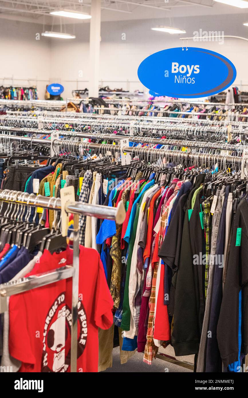 Multiple clothing racks in a thrift store(Good Will) in Ludington, Michigan, USA. Stock Photo