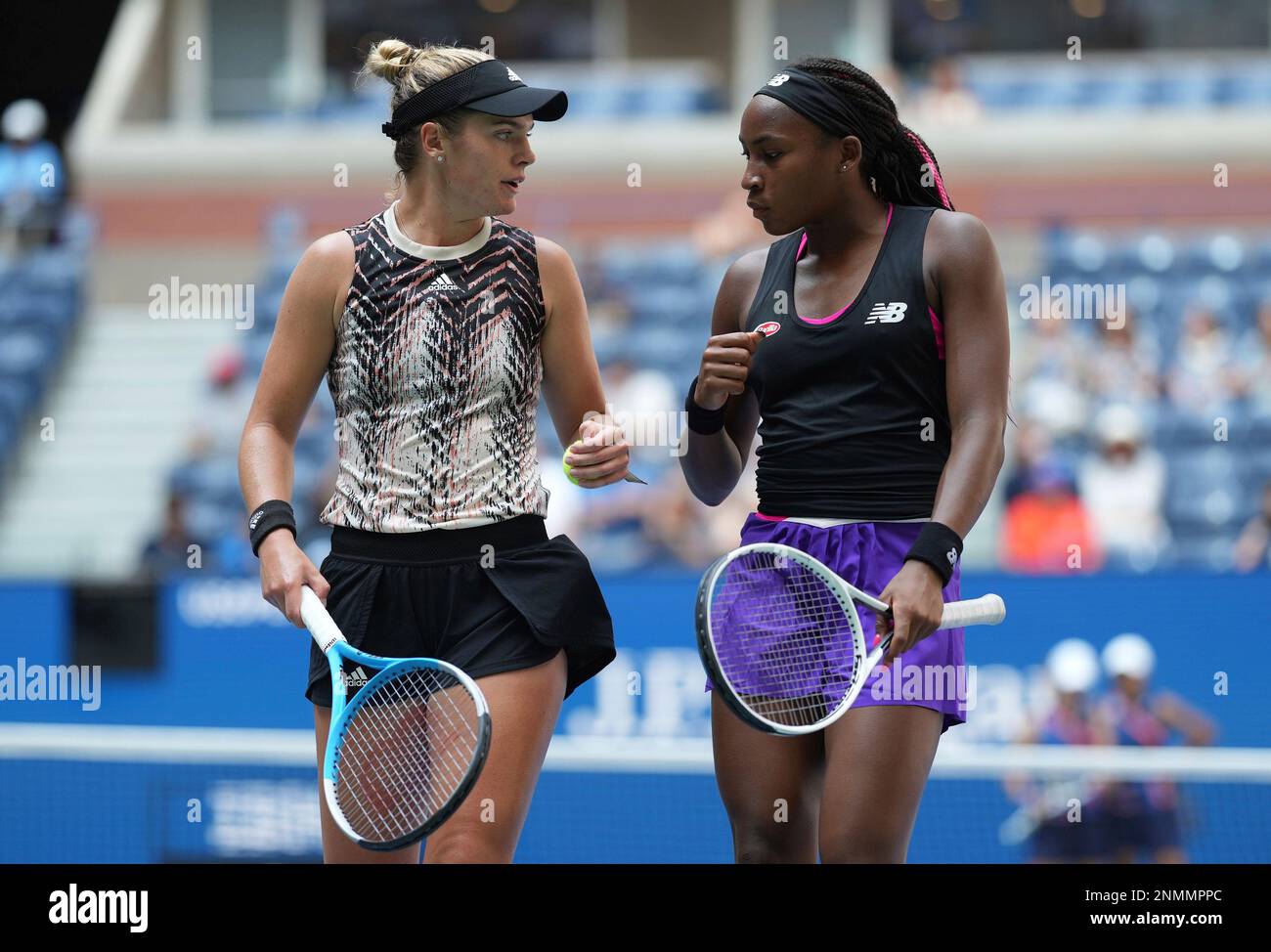Catherine McNally and Coco Gauff talk in between points during the