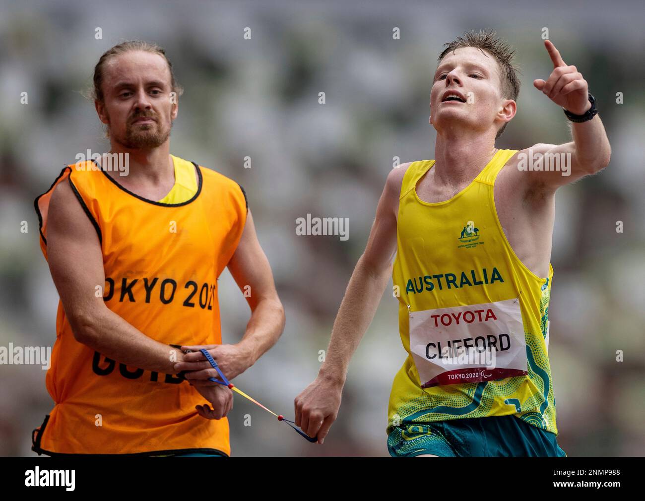 Jaryd Clifford of Australia and his guide approach the finish line to ...