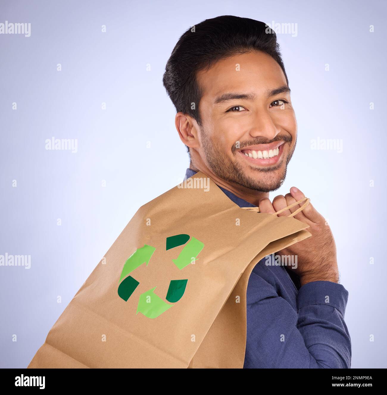 Man in portrait, happy and recycling paper bag, environment and