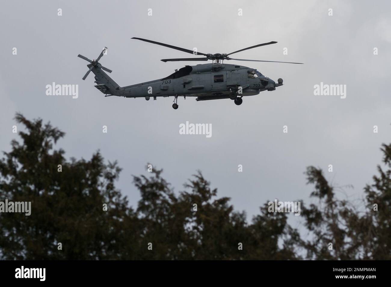 A Sikorsky SH-60 Seahawk helicopter with the US Navy Helicopter Maritime Strike Squadron (HSM-51, known as the War Lord) flying near NAF Atsugi, Japan Stock Photo