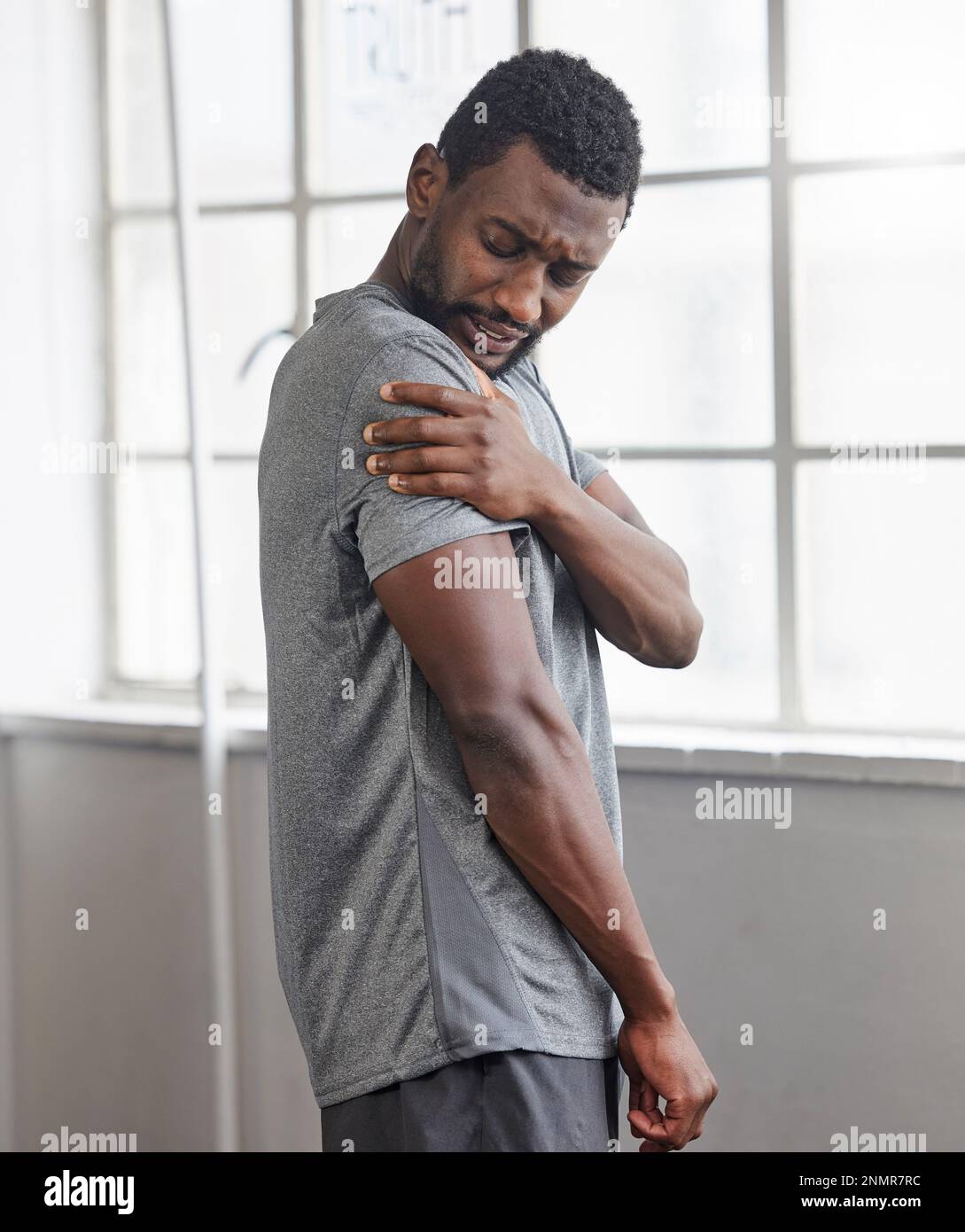 Shoulder injury, black man and pain in gym from exercise, medical emergency and injured muscle