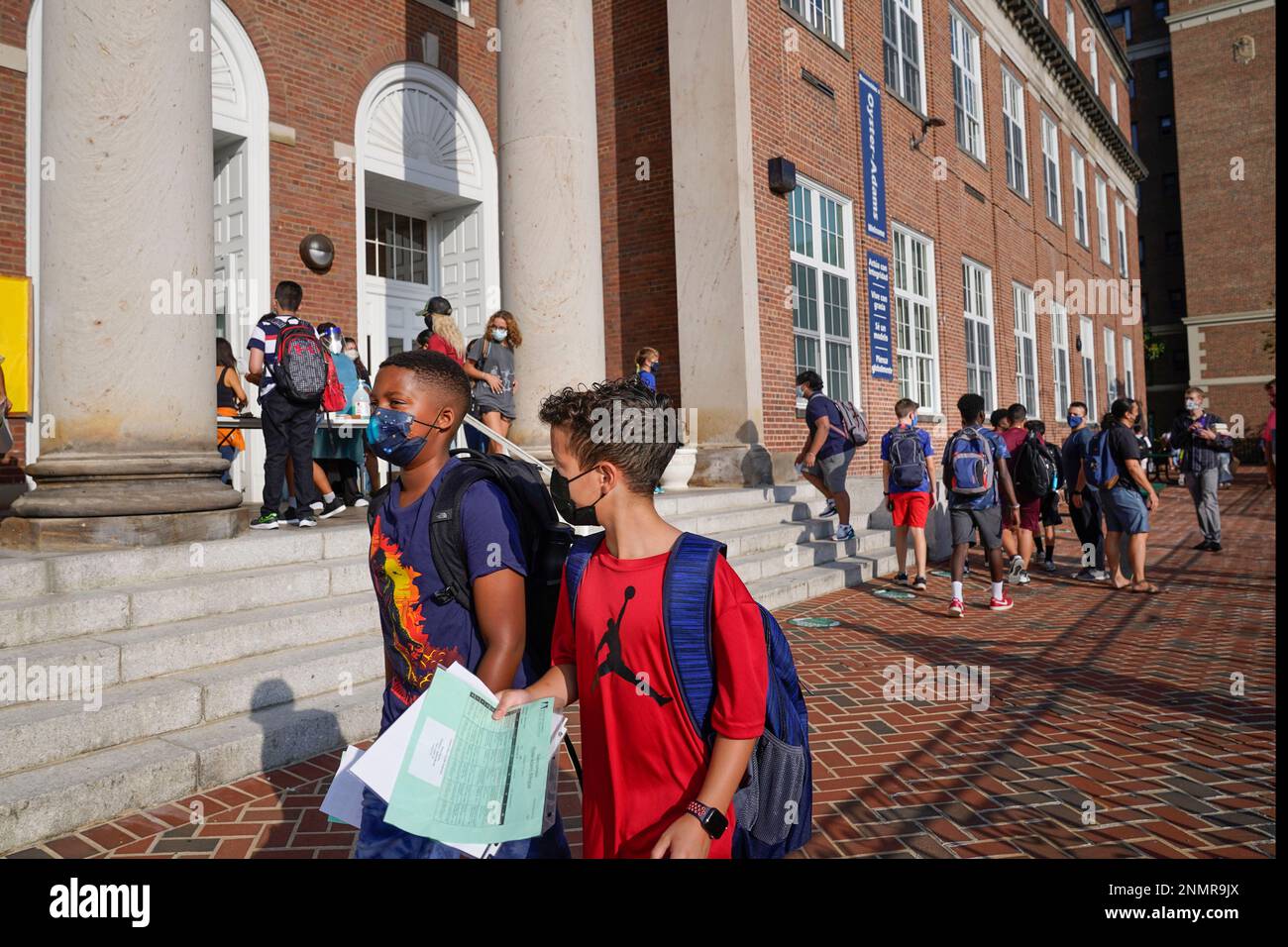Students begin arriving at the main entrance of the Adams campus of
