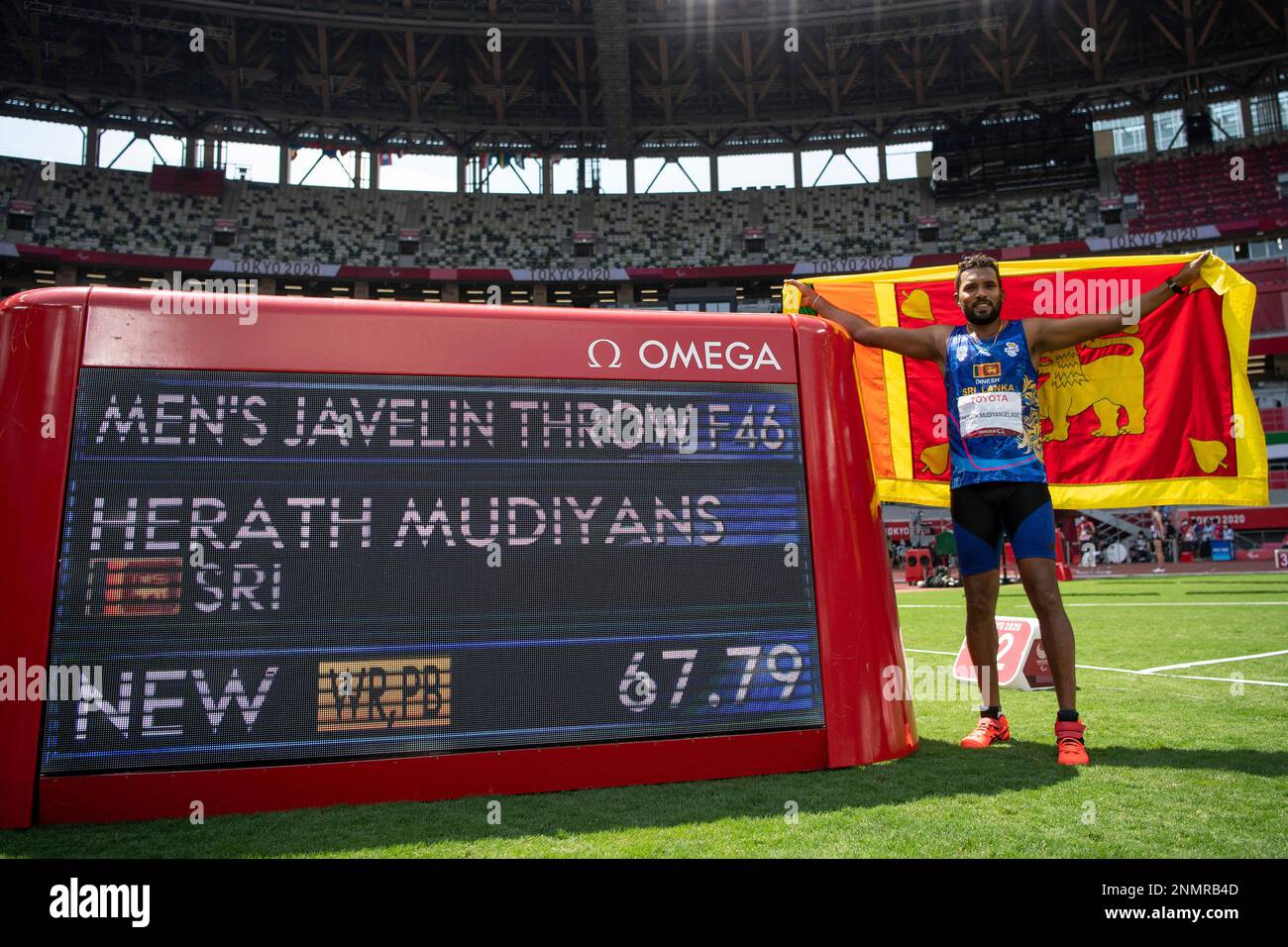 Gold medallist Dinesh Priyantha of Sri Lanka stands next to the