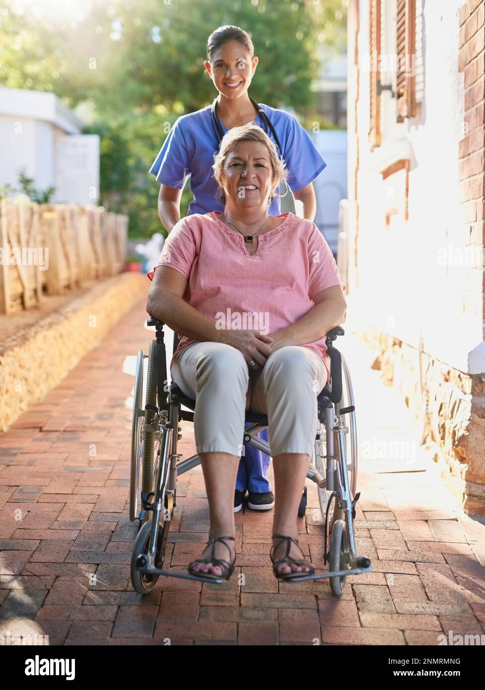 Out for some fresh air. Portrait of a caregiver pushing a senior patient in  a wheelchair outside Stock Photo - Alamy
