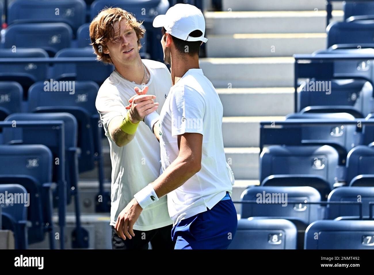 Andrey Rublev shakes hands with Novak Djokovic during practice at the 2021 US Open, Wednesday, Aug