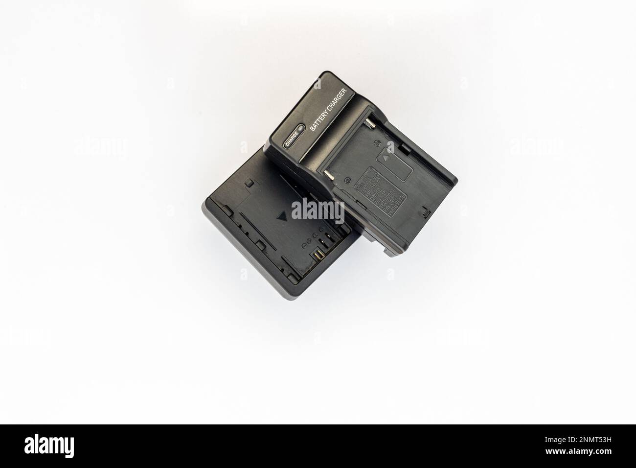 Digital camera and lighting equipment chargers isolated on white