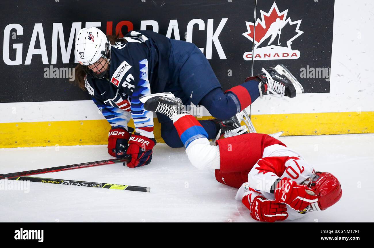 Russia's Anna Shibanova, right, grabs her helmet after colliding with Abbey  Murphy, of the United States, during the first period of a match at the  International Ice Hockey Federation (IIHF) Women's World