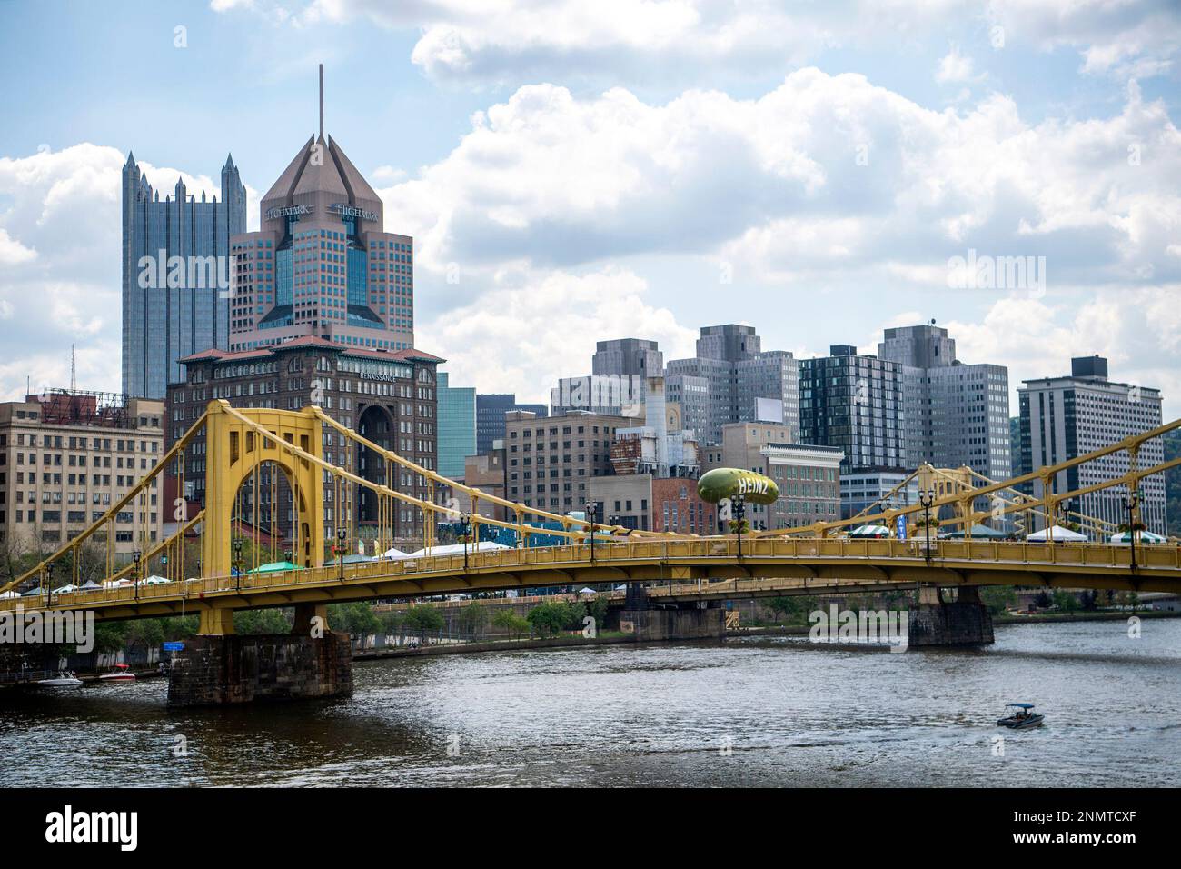 The Heinz pickle balloon floats above the Andy Warhol Bridge during
