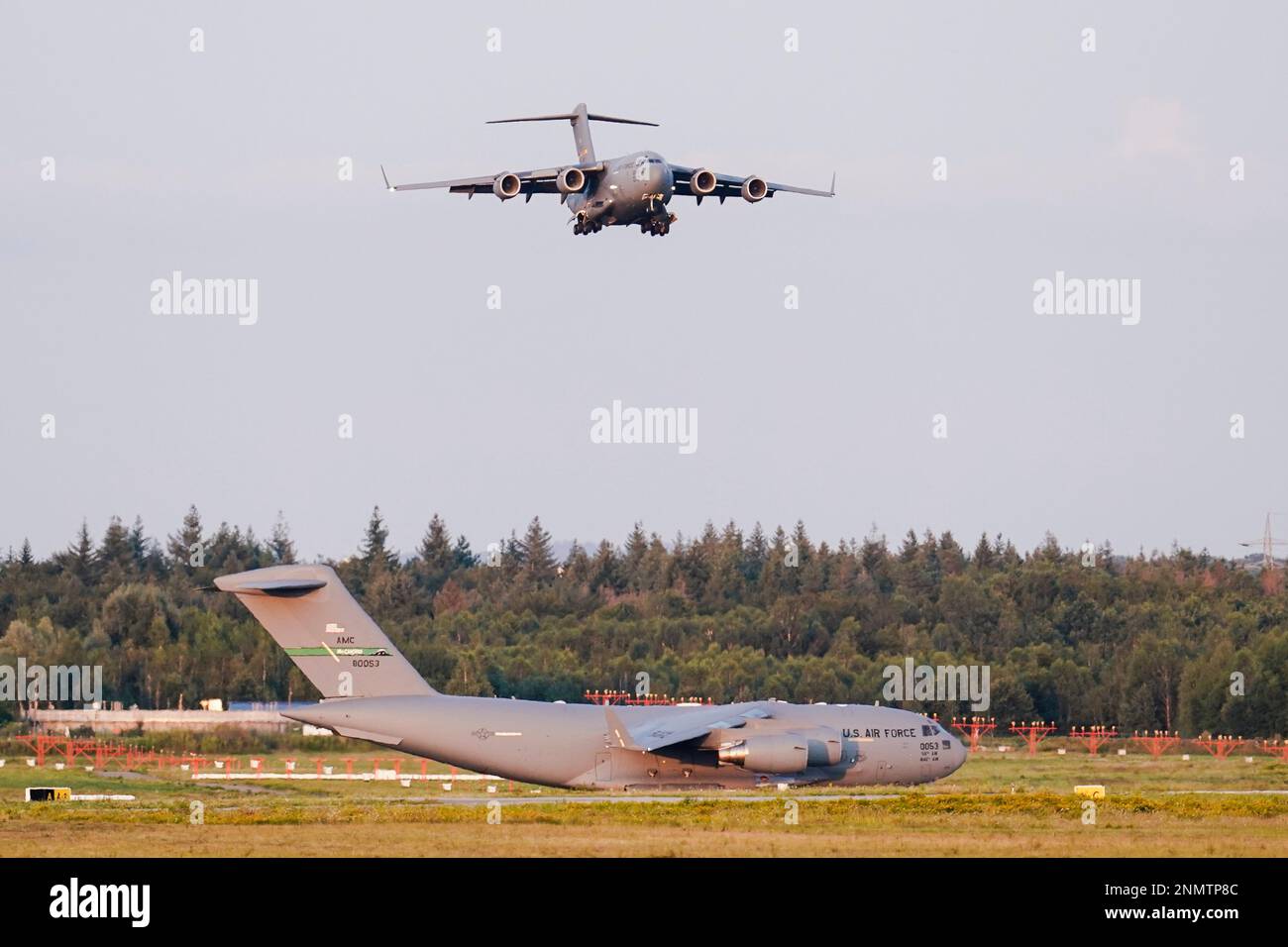 A transport plane carrying people flown out of Afghanistan lands at