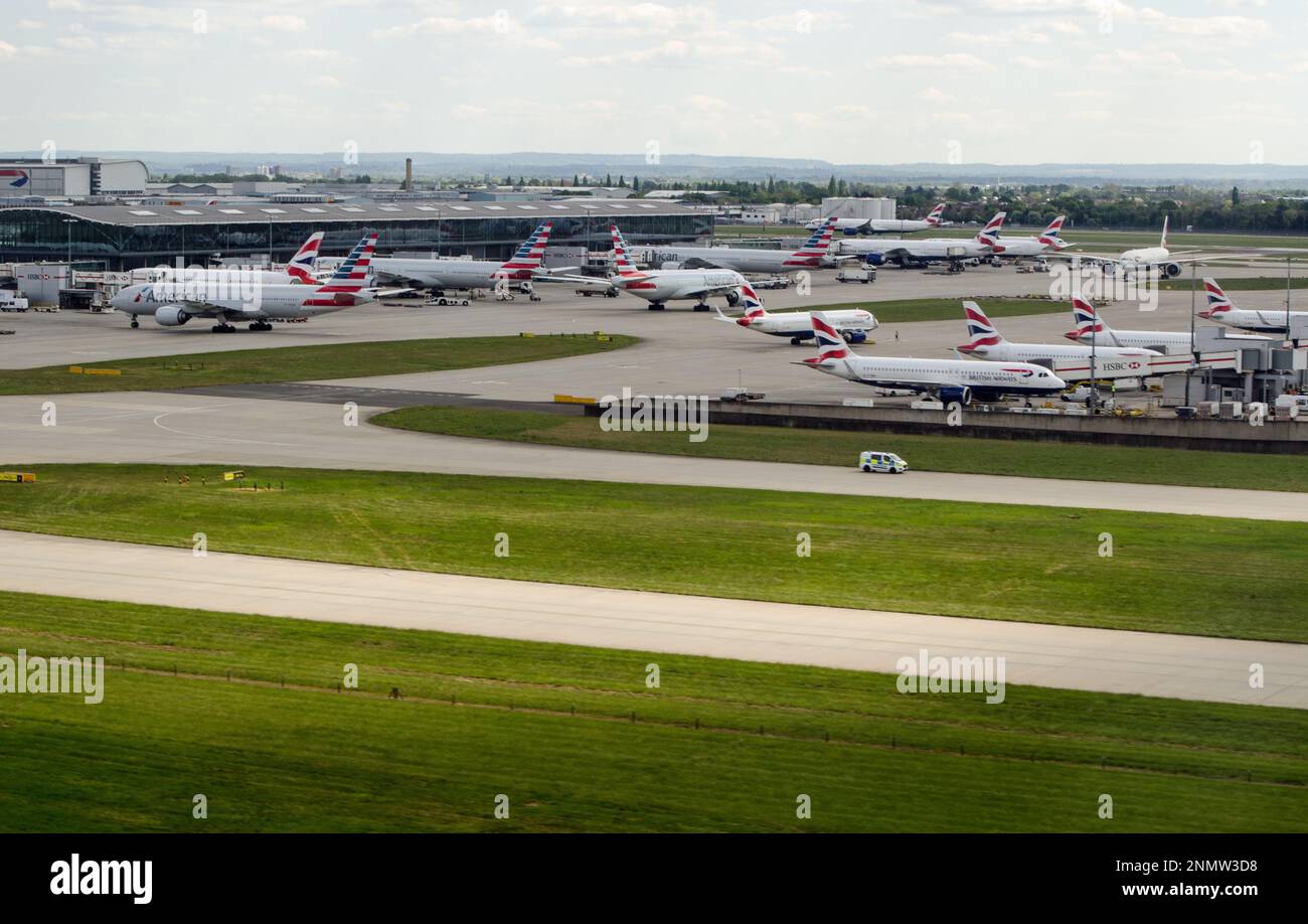 Heathrow, UK - April 26, 2022: Aerial view of Terminal 5 at Heathrow Airport on a sunny spring afternoon with planes from American Airlines and Britis Stock Photo