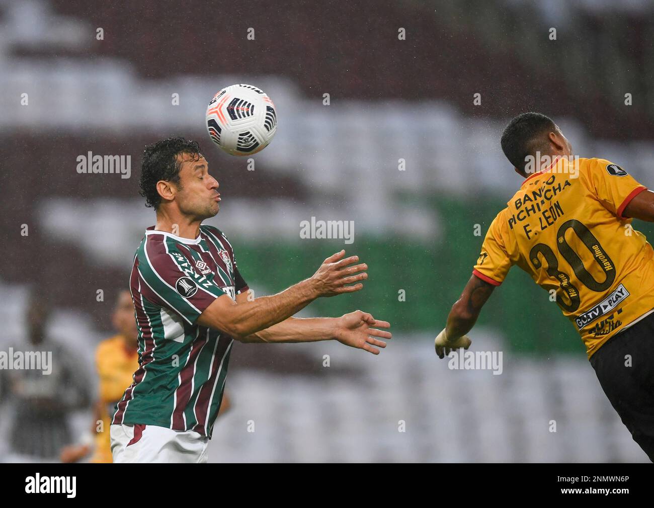 Fred of Brazil's Fluminense heads the ball as Luis Leon of Ecuador's  Barcelona defends during a Copa Libertadores quarterfinal first leg soccer  match at the Maracana stadium in Rio de Janeiro, Brazil