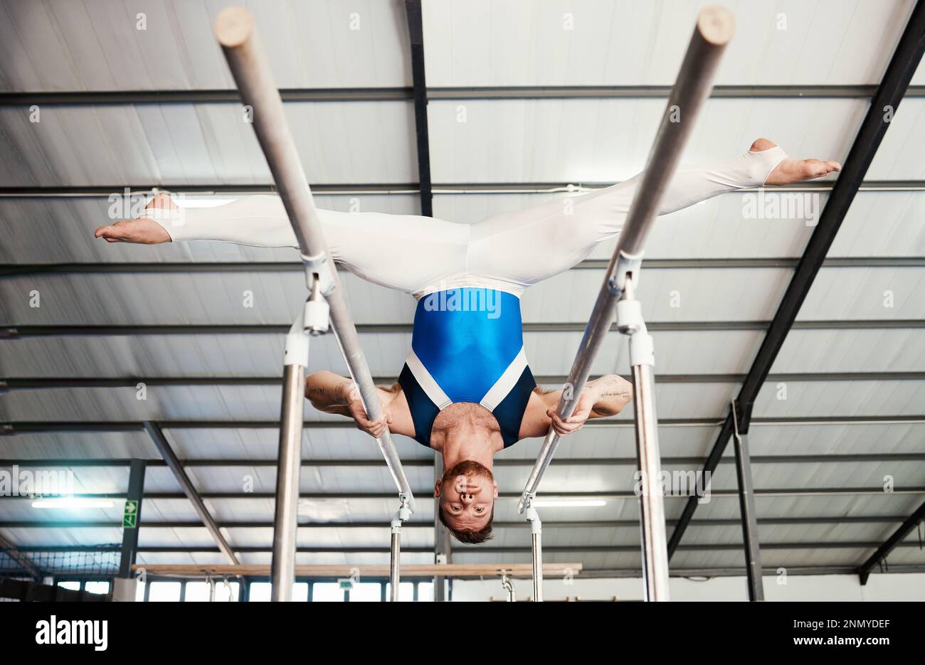 Gymnast man, bars and exercise with balance, strong body and focus for