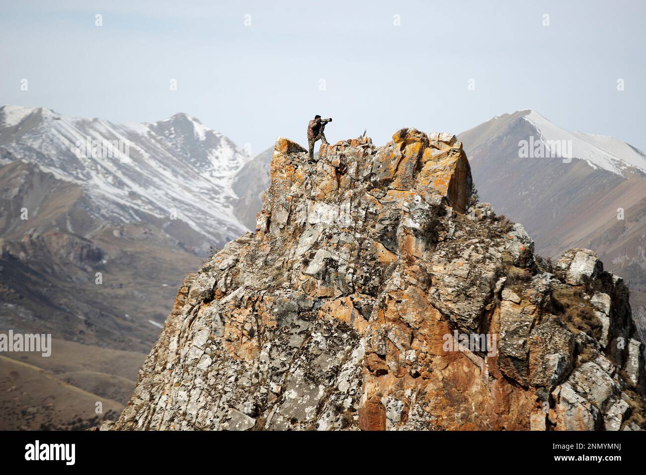 (230225) -- YUSHU, Feb. 25, 2023 (Xinhua) -- Gecho Chopee takes photos while patrolling at the Angsai Canyon in Angsai Township of Zaduo County, Yushu Tibetan Autonomous Prefecture, northwest China's Qinghai Province, Feb. 22, 2023. Gecho Chopee is an ecological ranger of Sanjiangyuan National Park. He is responsible for patrolling a section of the Angsai Canyon in Qinghai Province.   The unique climatic and geographical conditions have created a diverse ecosystem in the Angsai Canyon and made it a good habitat for a number of rare species such as snow leopards, Tibetan blue bear, lynx and whi Stock Photo