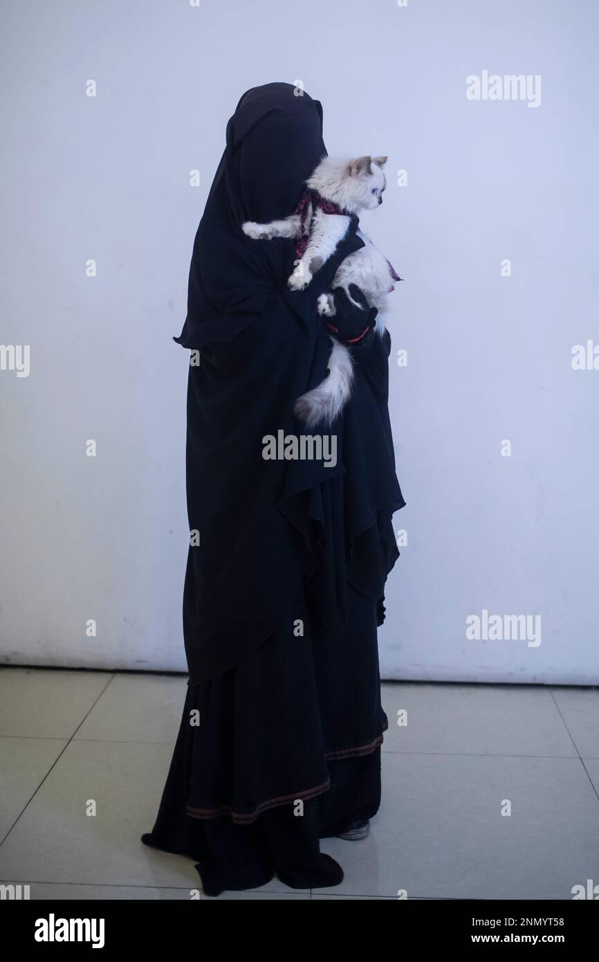 Dhaka, Bangladesh. 24th Feb, 2023. A cat owner shows off her pet cat