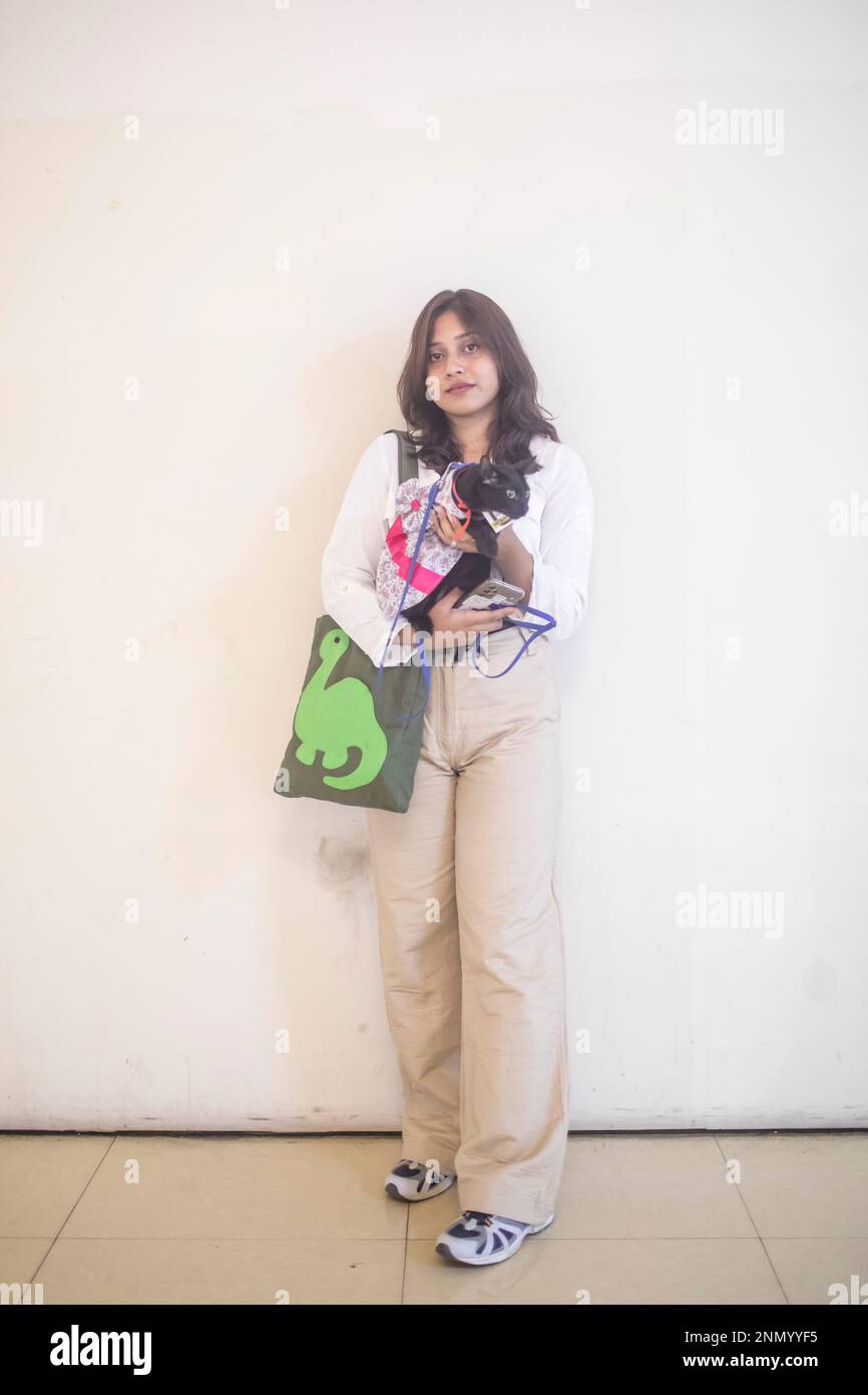 Dhaka, Bangladesh. 24th Feb, 2023. A cat owner shows off her pet cat