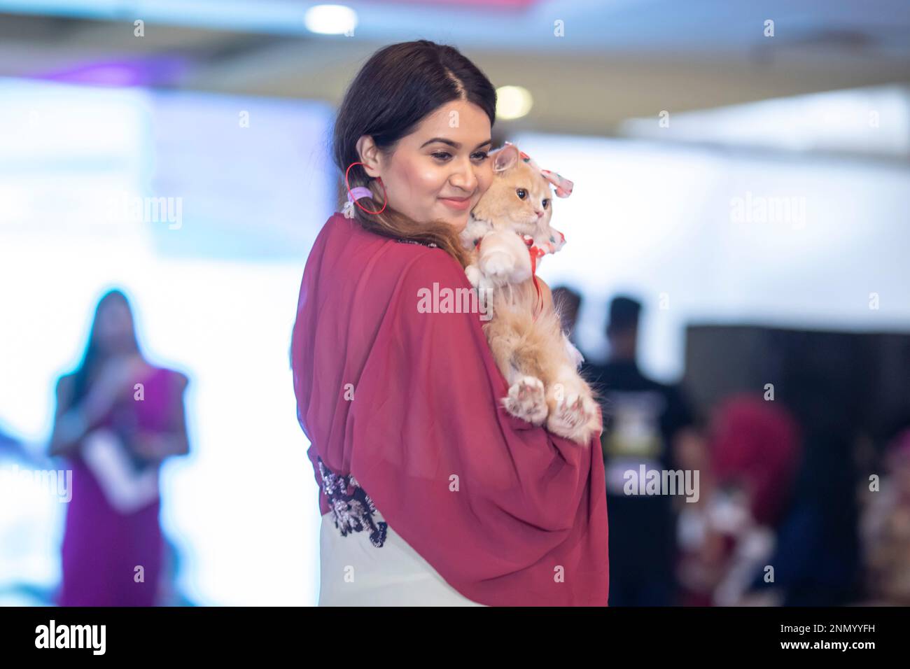 Dhaka, Bangladesh. 24th Feb, 2023. A cat owner shows off her pet cat
