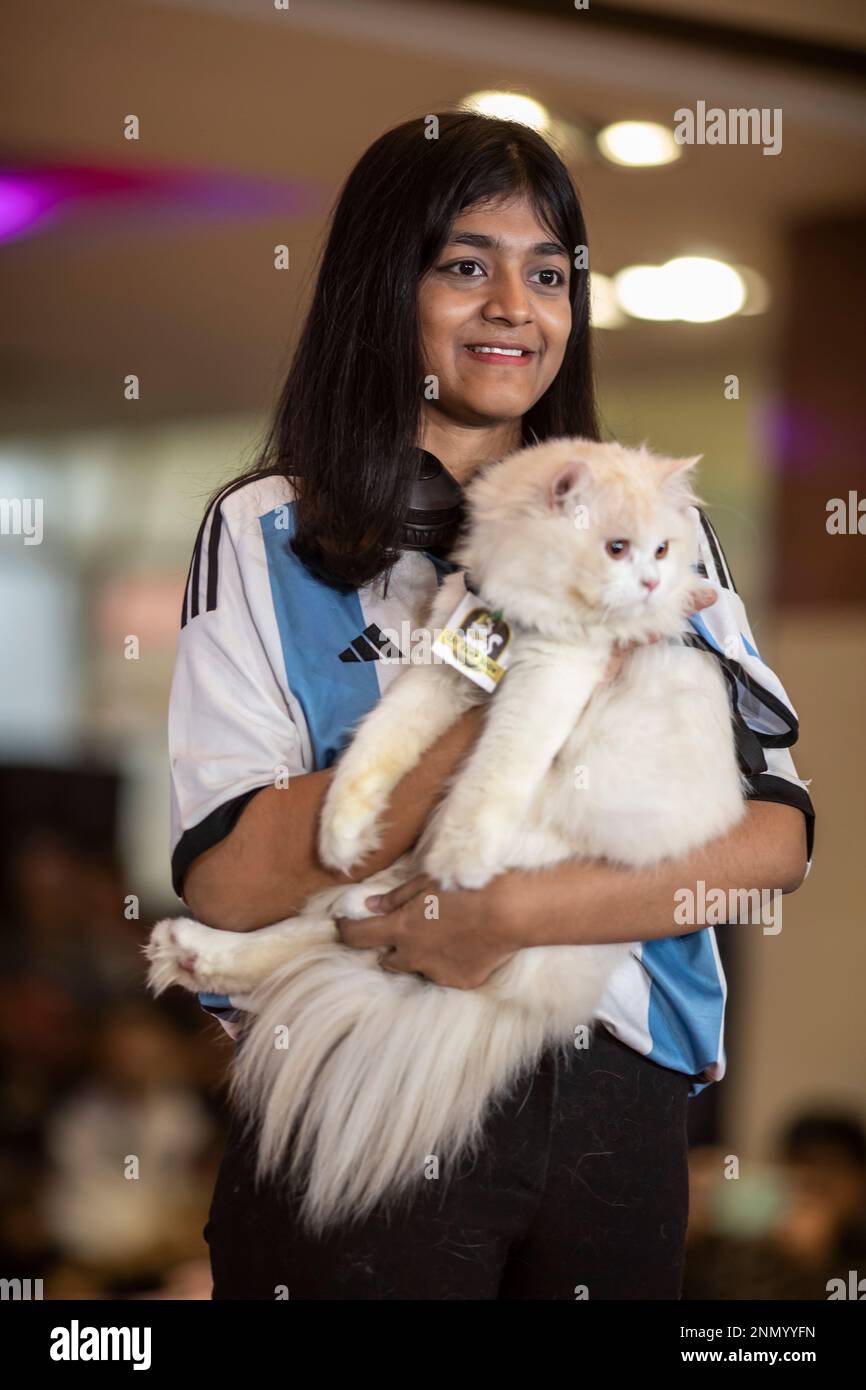 Dhaka, Bangladesh. 24th Feb, 2023. A young girl shows off her pet cat
