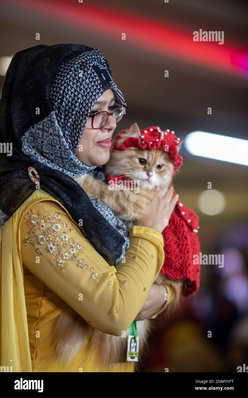 Dhaka, Bangladesh. 24th Feb, 2023. A cat owner shows off her pet cat