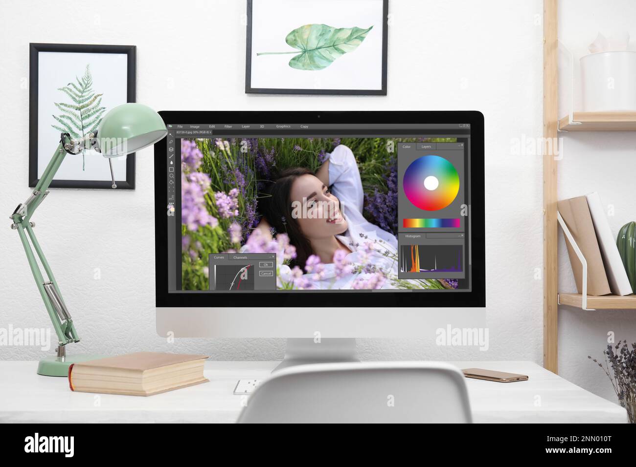 Designer's workplace. Computer with photo editor application on table indoors Stock Photo