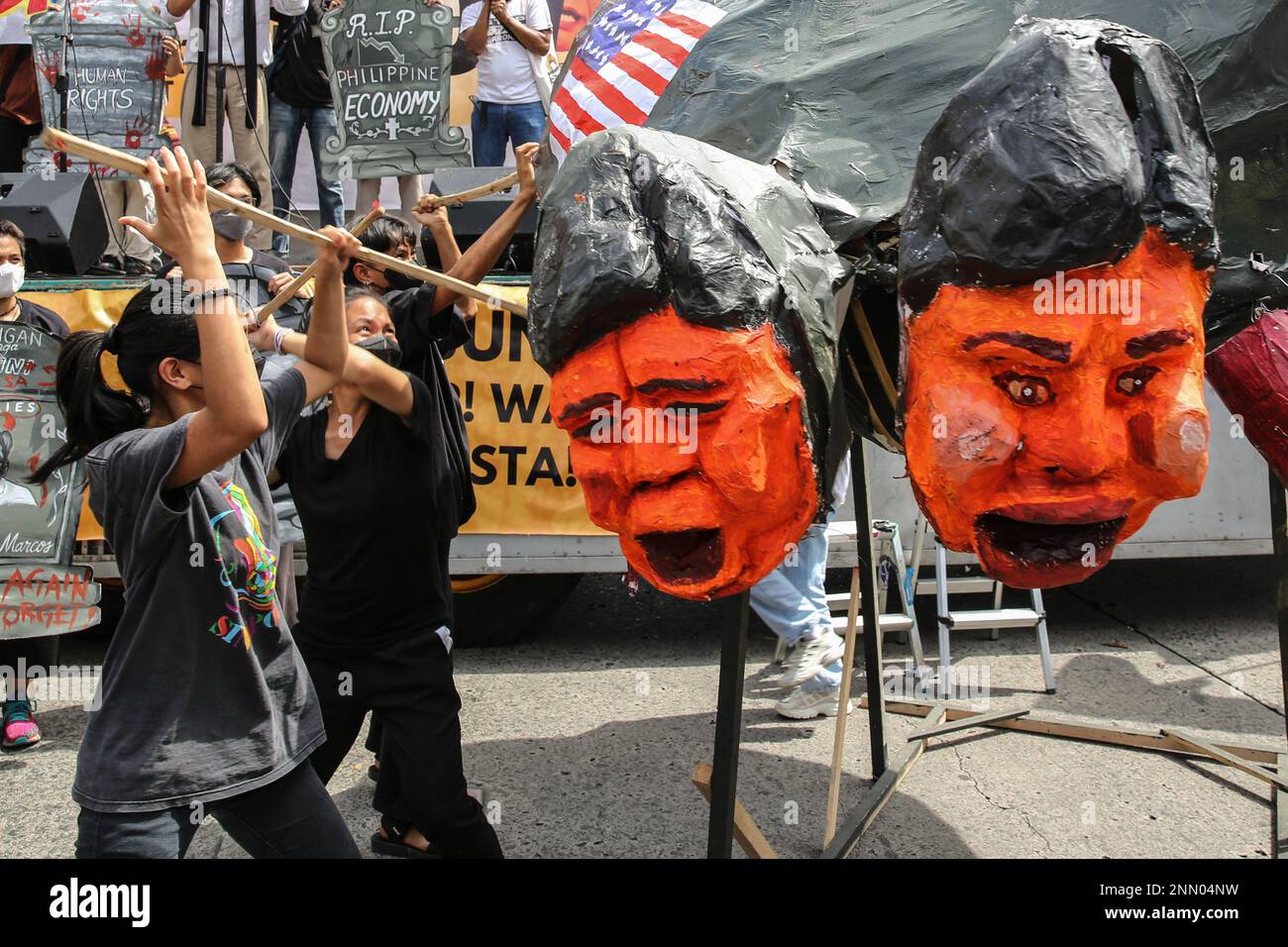 Quezon, Philippines. 25th Feb, 2023. Protesters destroy an effigy depicting the Philippine President Ferdinand Marcos Jr. and former President Rodrigo Duterte during 37th anniversary of the People Power Revolution. Demonstrators hold a protest in the EDSA People Power monument in celebration of the 37th anniversary of the People Power Revolution. It is also the first People Power Anniversary under Marcos Jr.'s administration. Credit: SOPA Images Limited/Alamy Live News Stock Photo