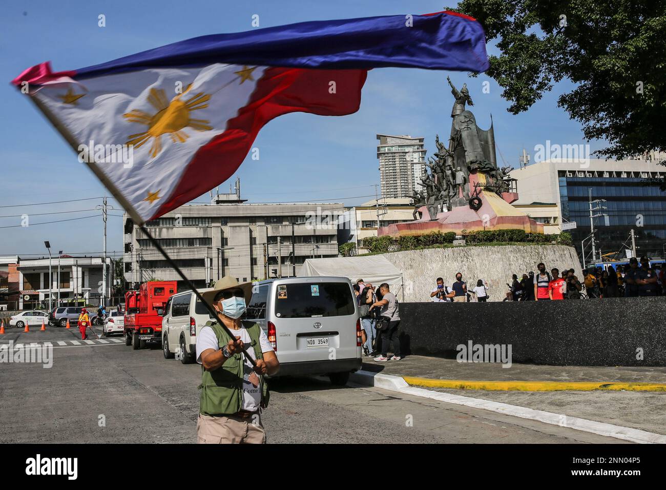 Quezon, Philippines. 25th Feb, 2023. A protester waves a Philippine flag during a demonstration. Demonstrators hold a protest in the EDSA People Power monument in celebration of the 37th anniversary of the People Power Revolution. It is also the first People Power Anniversary under Marcos Jr.'s administration. Credit: SOPA Images Limited/Alamy Live News Stock Photo
