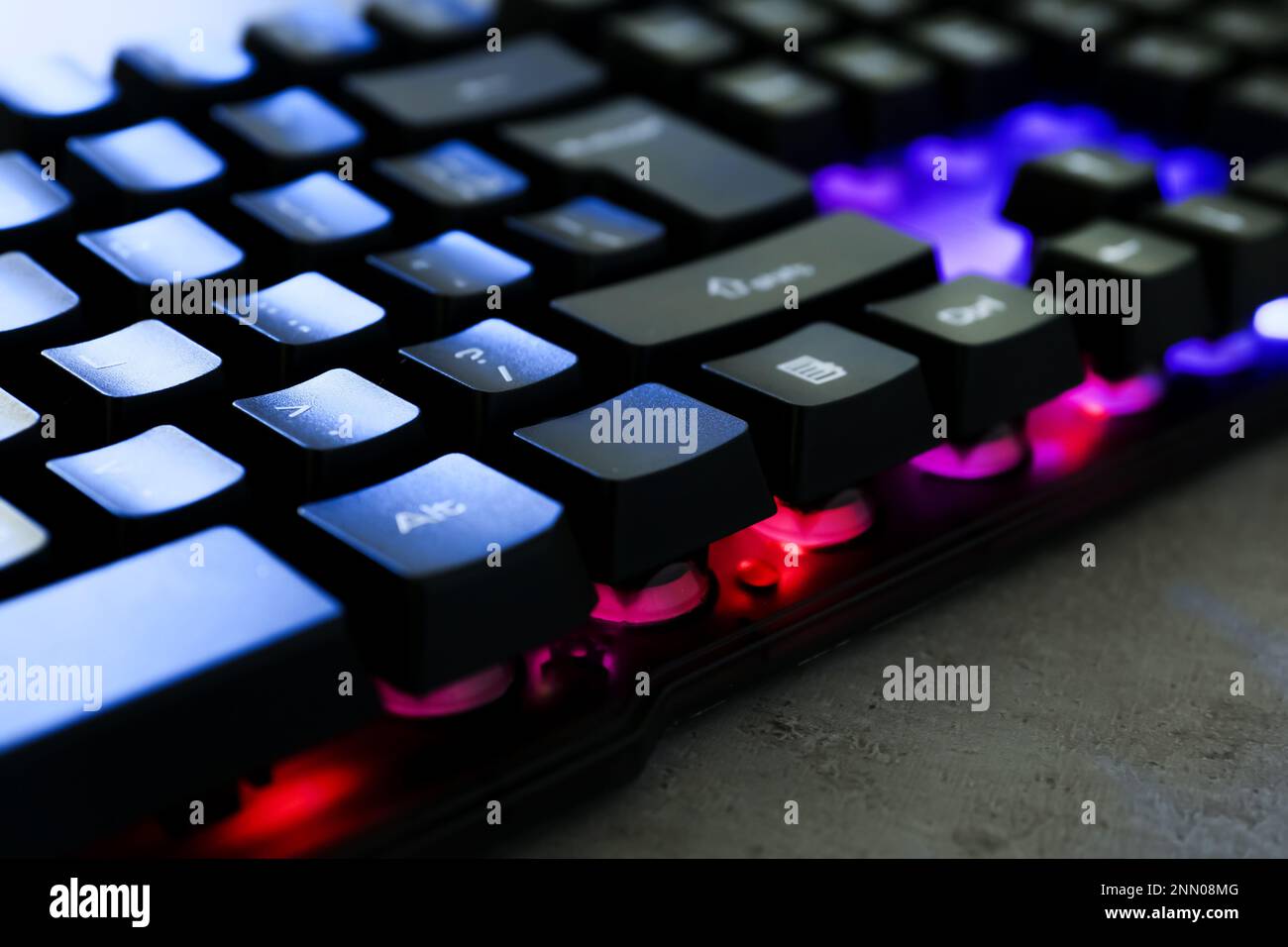 Modern keyboard with RGB lighting on grey table, closeup Stock Photo