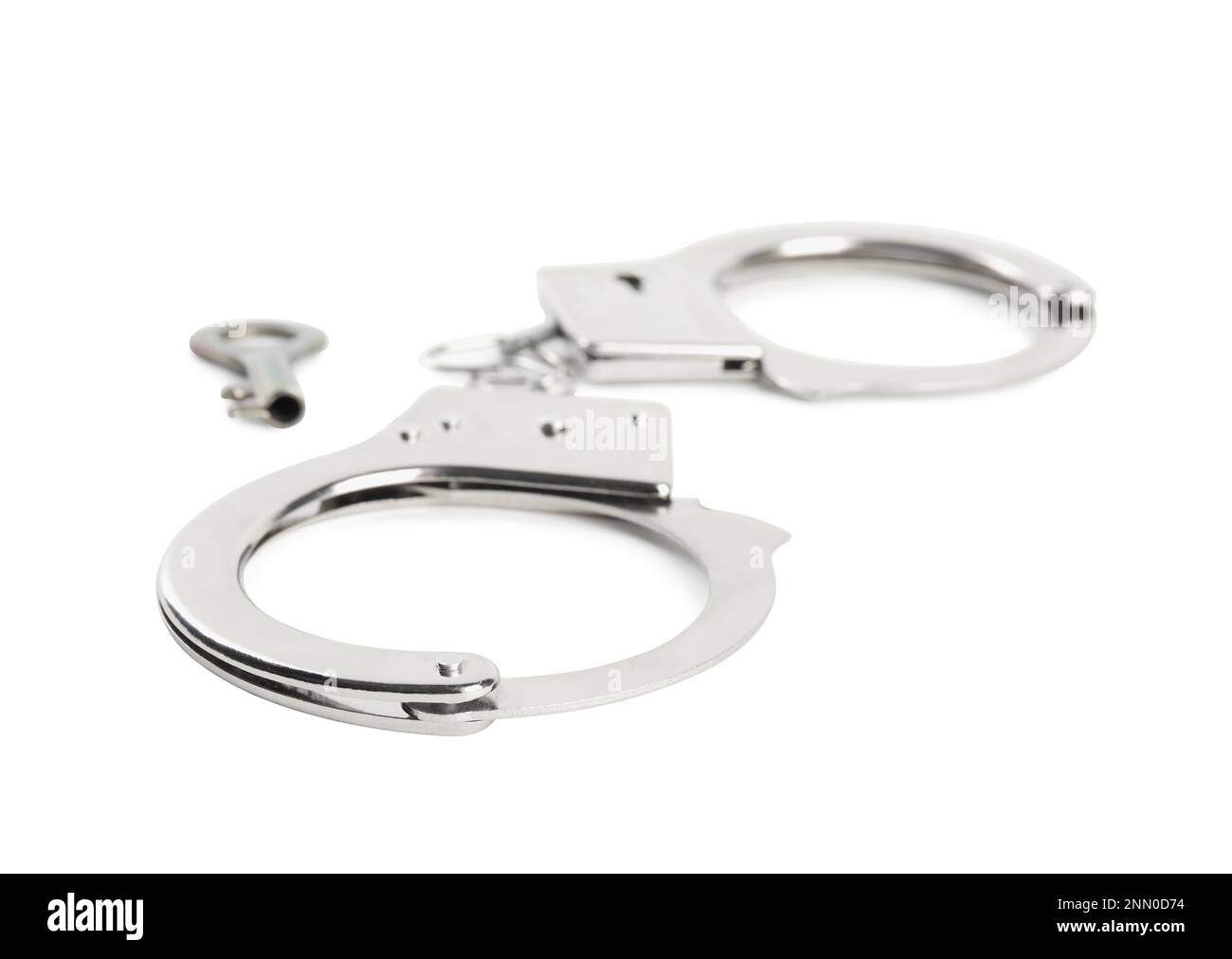 Classic chain handcuffs with key on white background Stock Photo Alamy