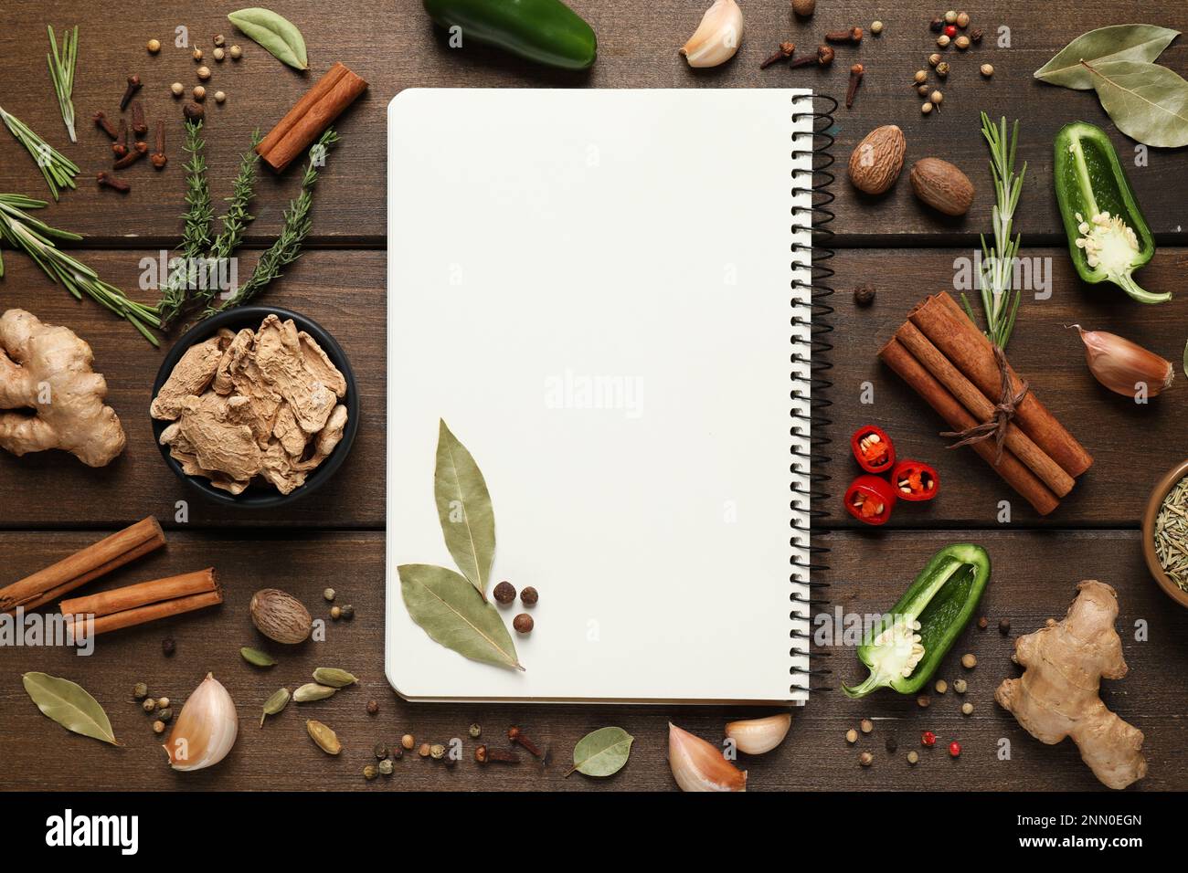 Blank recipe book and different ingredients on wooden table, flat lay. Space for text Stock Photo