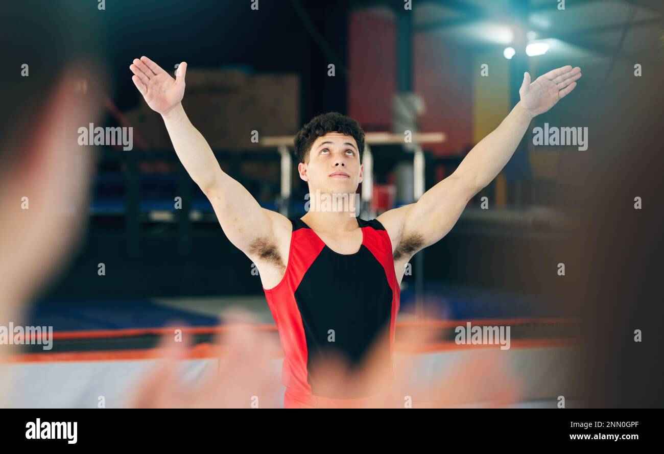 Gymnastics, performance and celebration of man in stadium after stunt