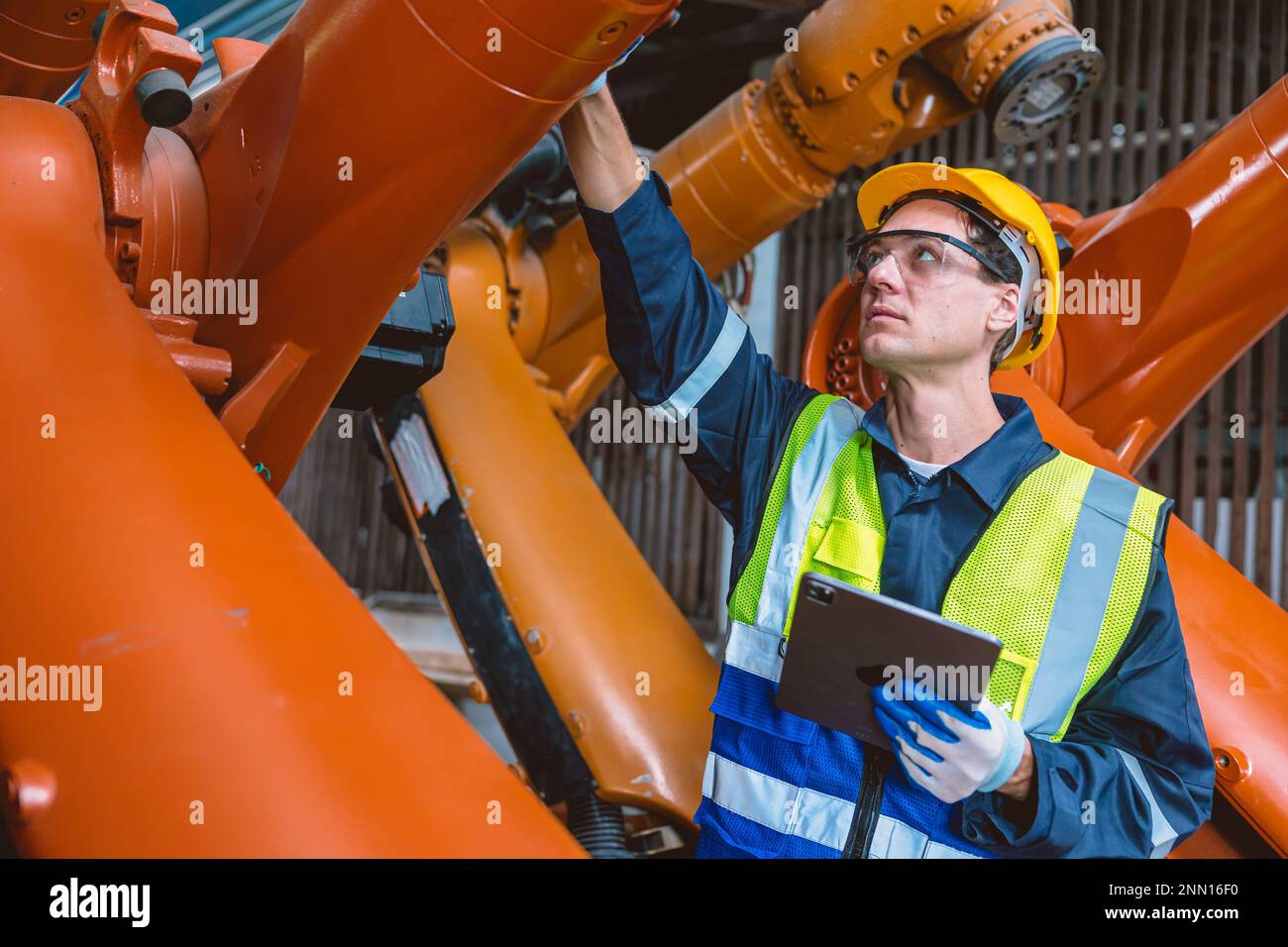 Automation Engineer Service Programming Robotic Arm. New Era Modern Machine Automatic Manufacturing Industry Concept. Stock Photo