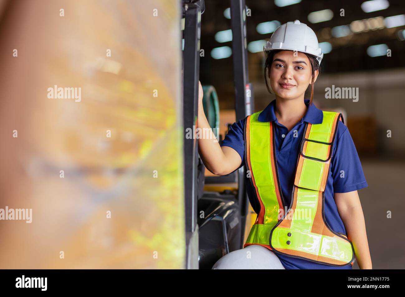 Indian woman staff worker engineer supervisor in safety suit work in