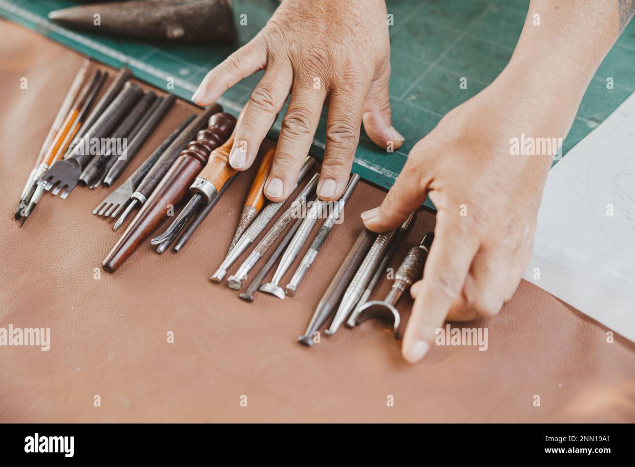 Leather Working Tools And Rolled Up Hide Organized Stock Photo