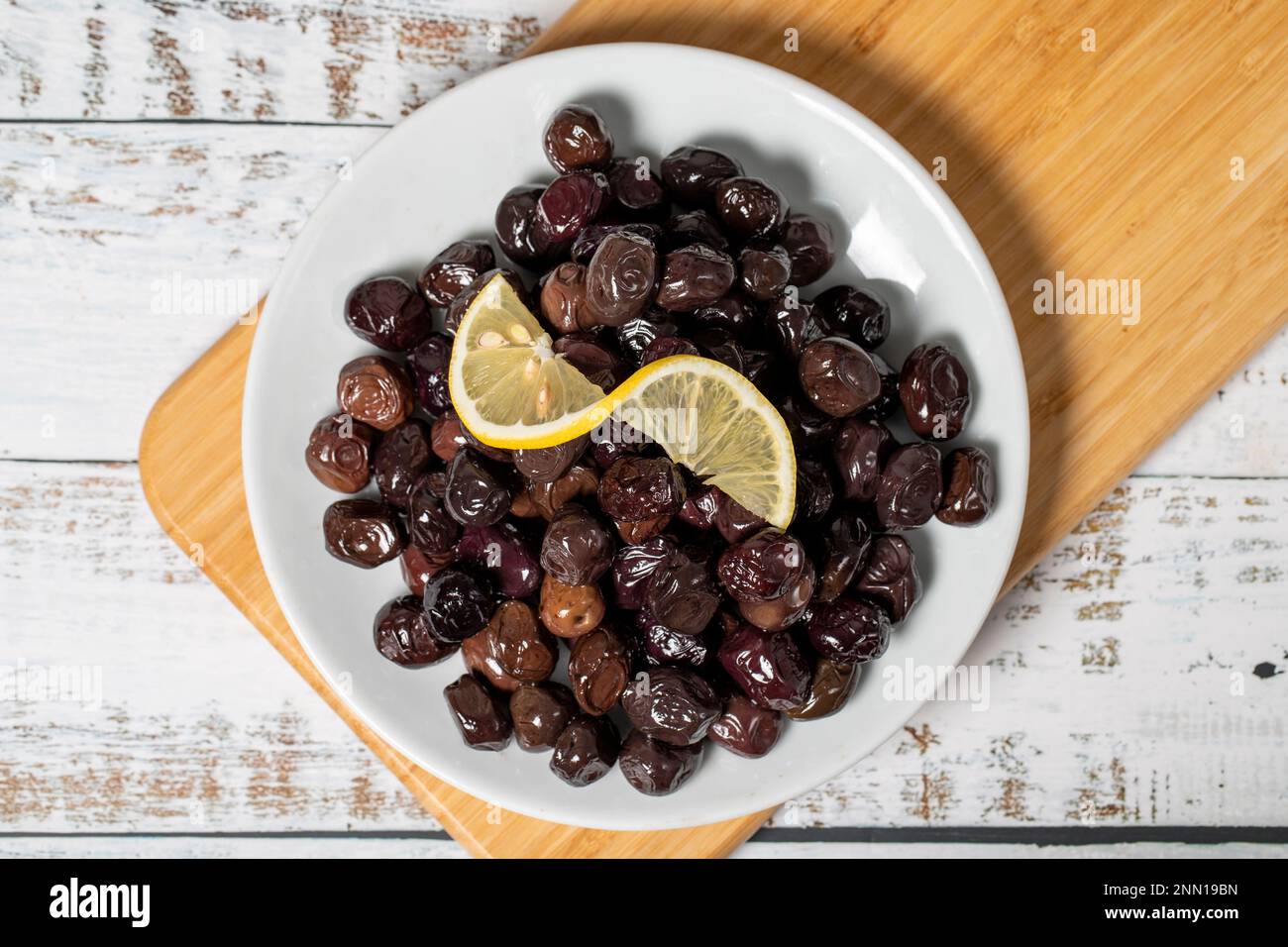 Black olive. Fermented olives and lemon slice in plate. Mediterranean