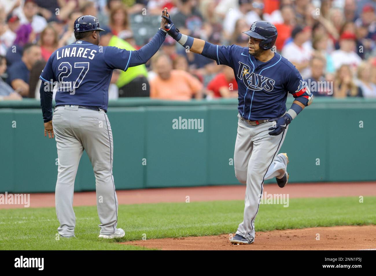 CLEVELAND, OH - JULY 23: Tampa Bay Rays designated hitter Nelson Cruz (23)  gets a high-five from Tampa Bay Rays third base coach Rodney Linares (27)  after hitting a home run during