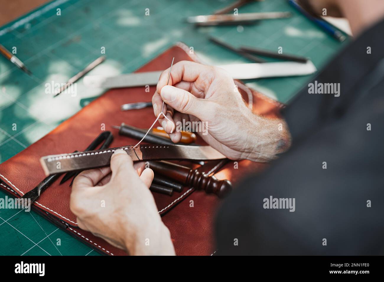 closeup hand working process leather handcraft in the leather