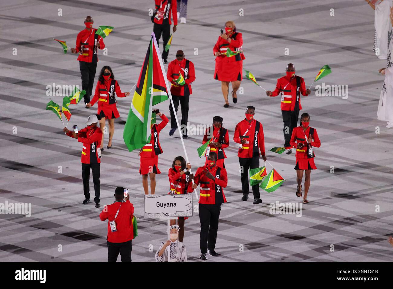 Guyana's delegation members attend the Parade of Athletes during the