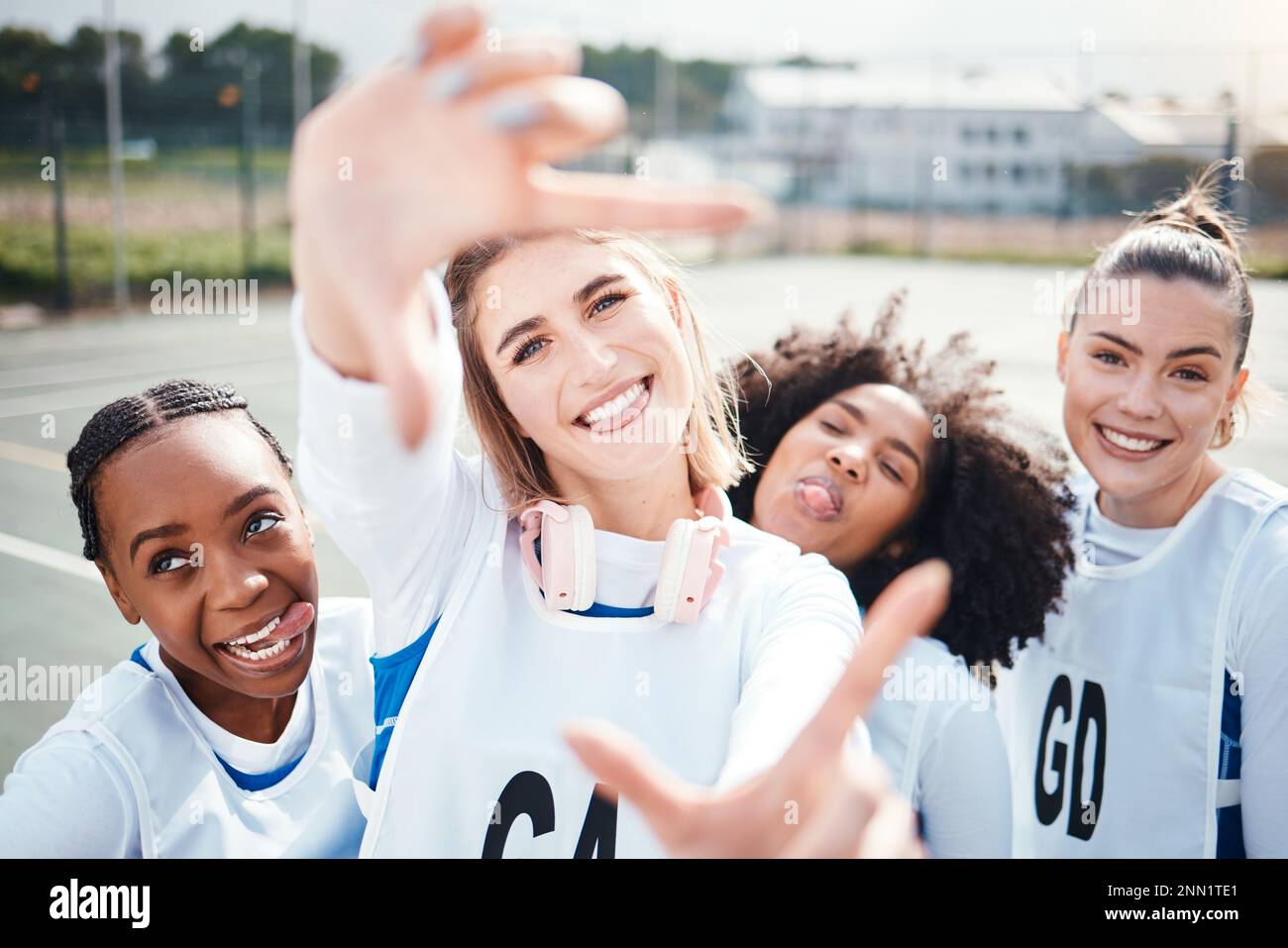 Selfie, frame and a woman sports team having fun on a court outdoor together for fitness or training. Portrait, netball and funny with a group of Stock Photo