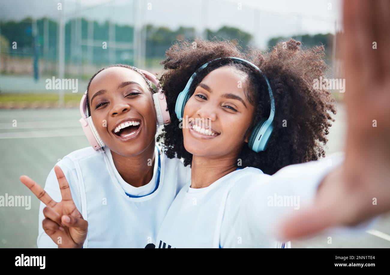 Friends, selfie and black women in portrait, netball and sports with team on court outdoor, smile and peace hand sign. Face, headphones and gen z with Stock Photo