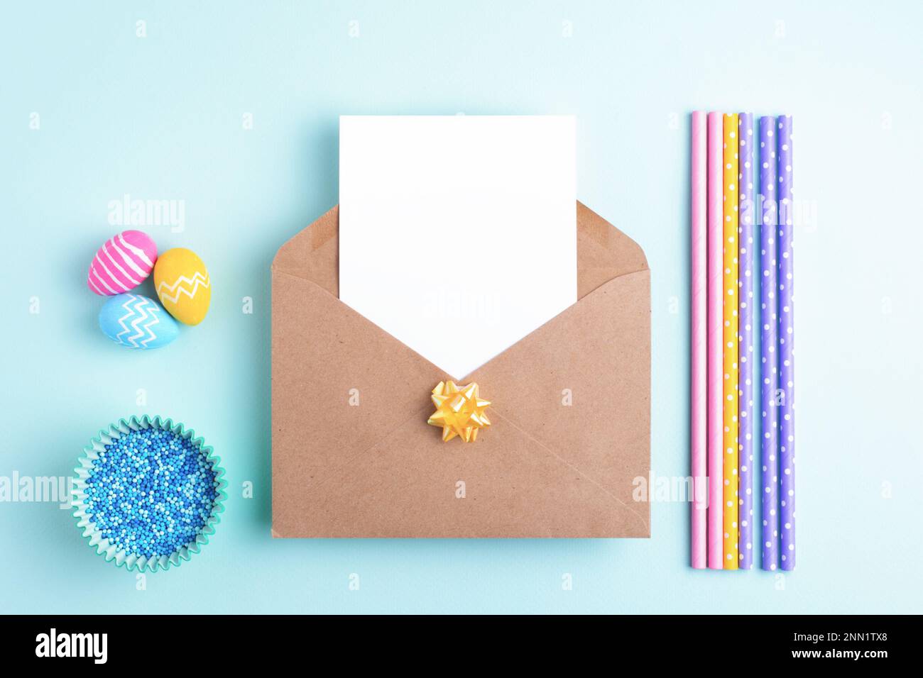 Easter background with empty card, easter eggs, holiday decoration. Flat lay, greeting concept, copy space. Stock Photo