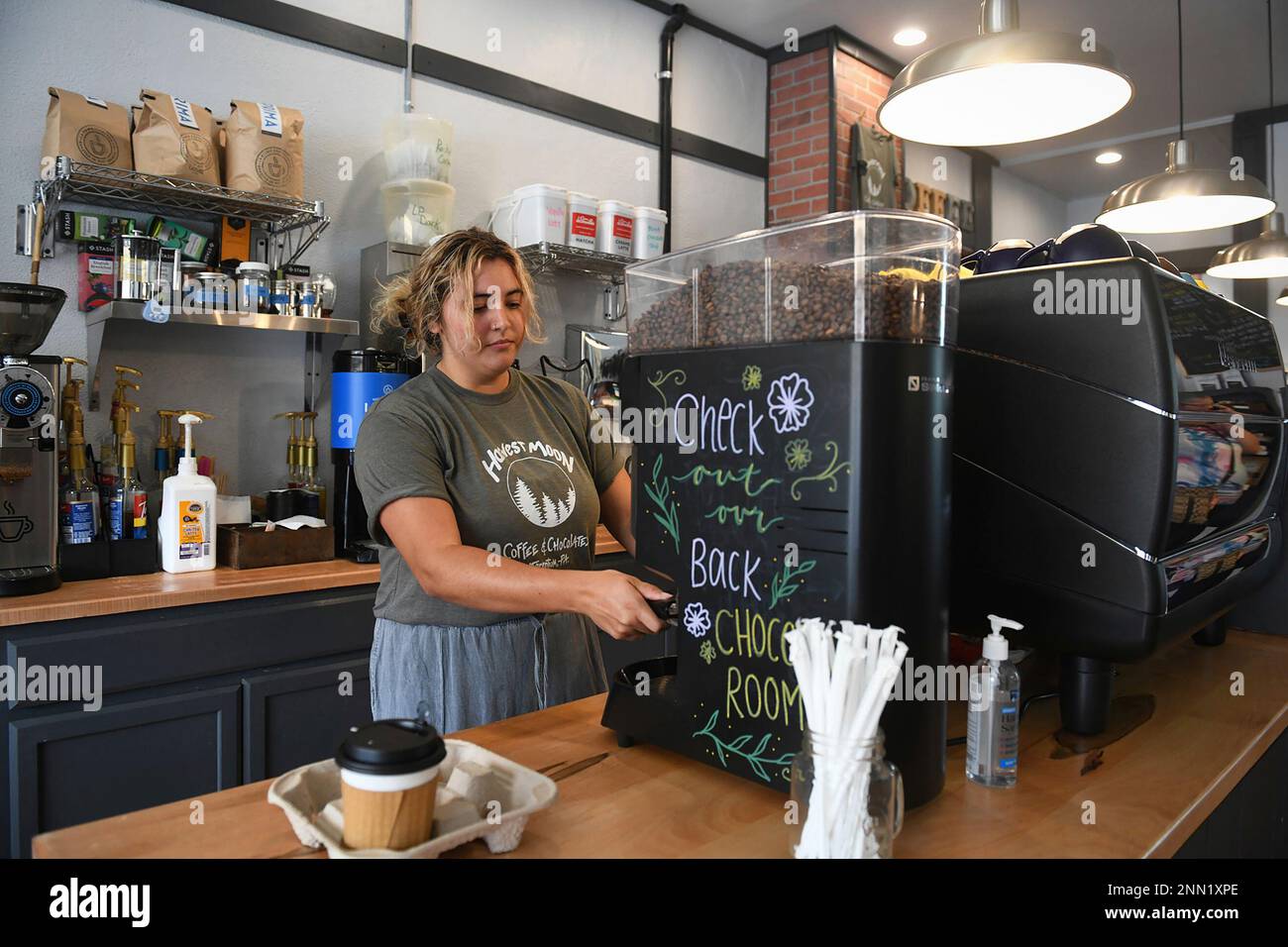 Teen worker Courtney Collins, 19, makes a drink at Harvest Moon Coffee