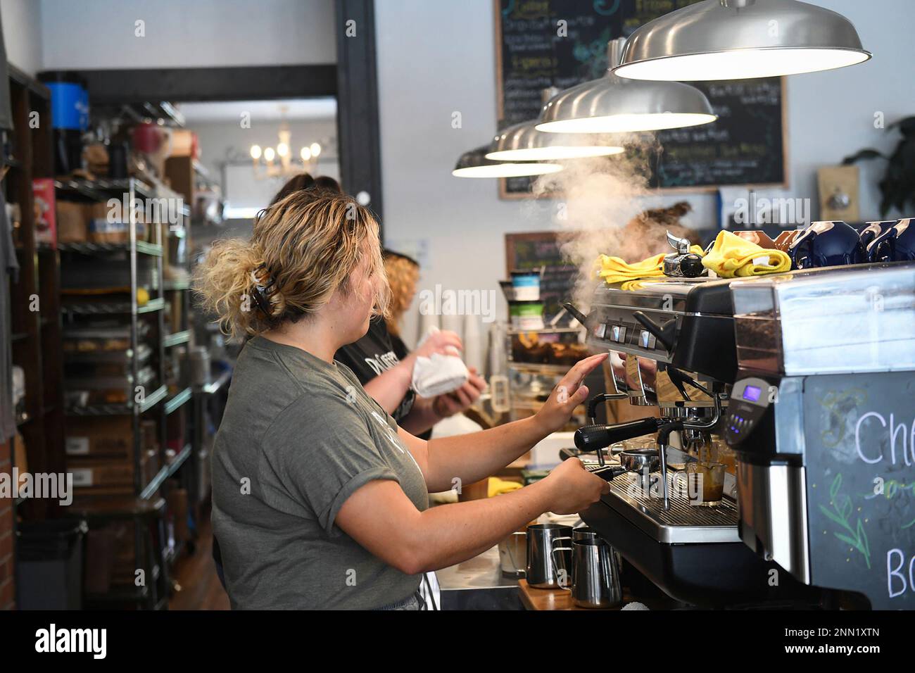 Teen worker Courtney Collins, 19, makes a drink at Harvest Moon Coffee